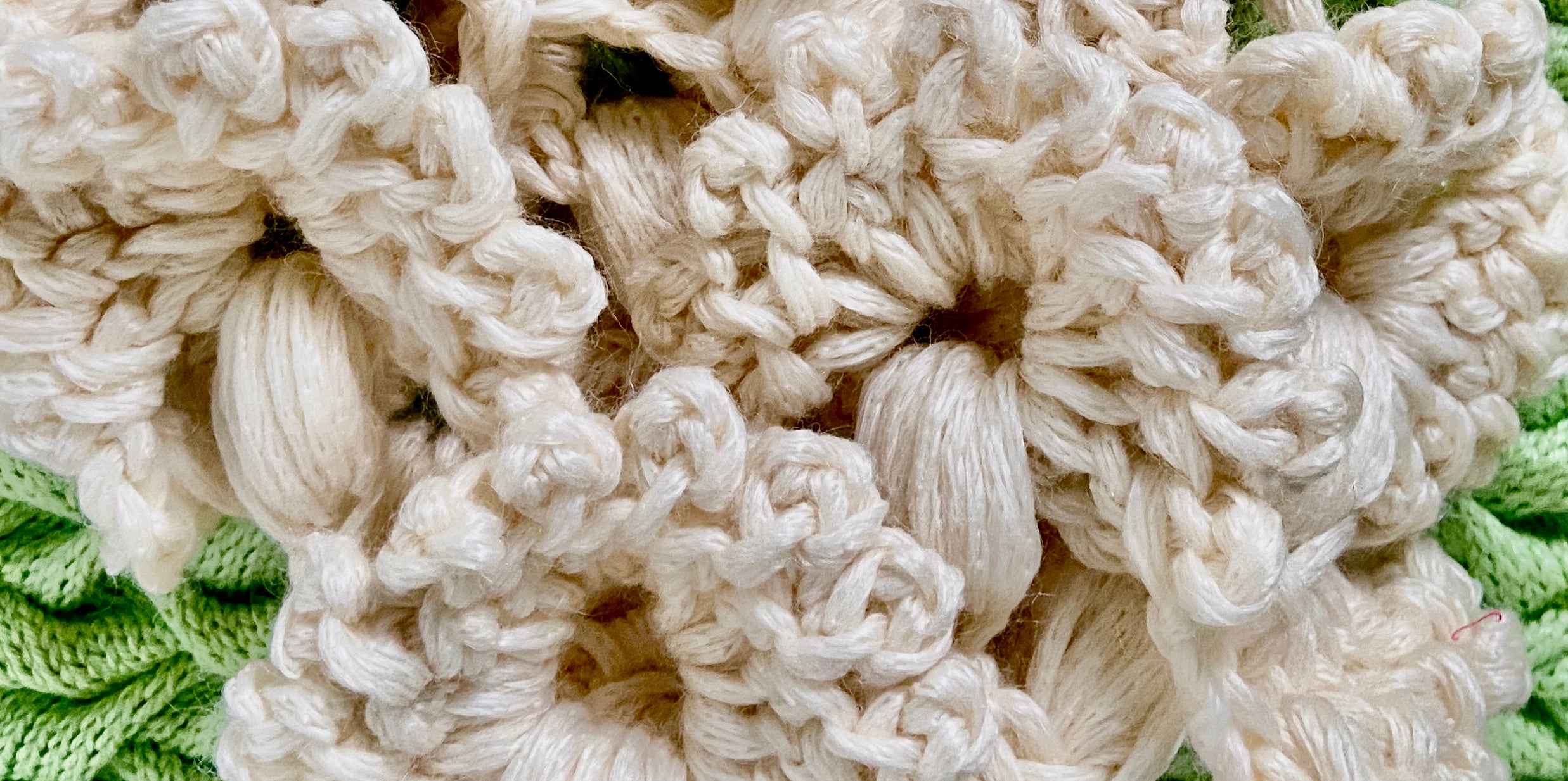 Extreme close up of white cap from the REVIVAL capsule collection by ACIEN x WOVENBEYOND. Crafted from the signature ACIEN coronation crochet textile using French merino D’arles wool and Himalayan nettle.