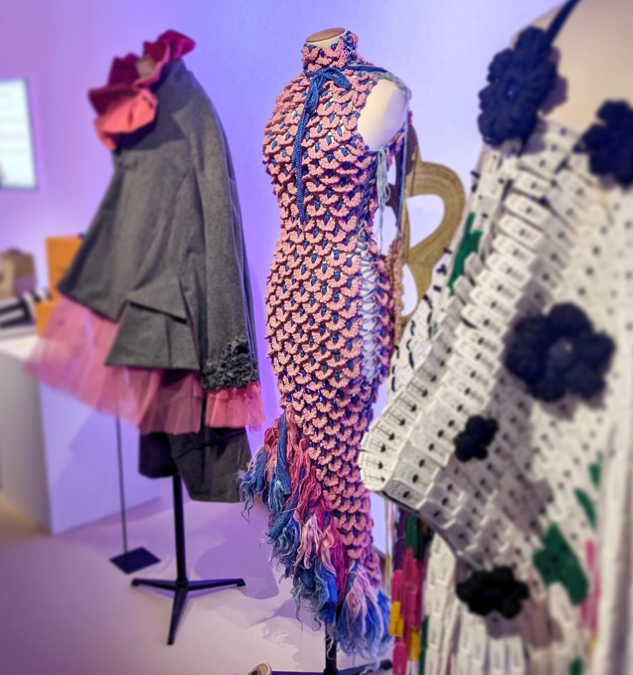 Look 1, LA ZARZAMORA from REGENERATIVE FOLKLORE, showcased at LVMH’s LIFE 360 Summit at UNESCO. Pink and purple crochet dress using signature ACIEN coronation crochet textile, made from pineapple yarn with pink and purple fur detail at the bottom.