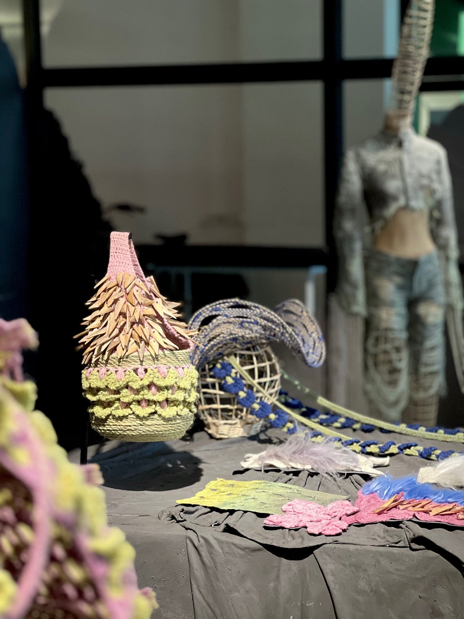 Showcase of the TABERNAS hat, green and pink crochet bag adored with hand cut Almería canes and REGENERATIVE FOLKLORE textile samples at Dutch Design Week.